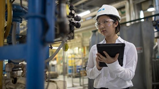 Woman with tablet in powerplant